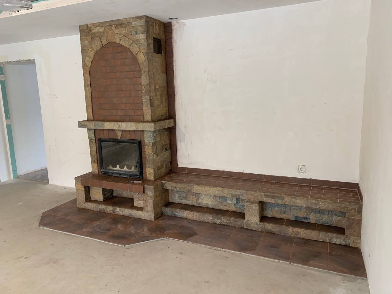 Kominek wyłożony kamieniem naturalnym i płytkami ceramicznymi